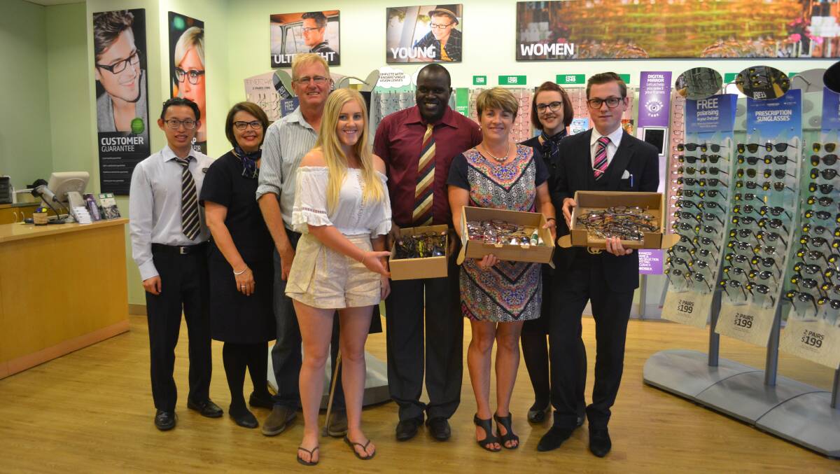 What a sight: 30-year-old Moses Goire, of Uganda, with his sponsor family Dione, Jack and Anna Carter, of Nyngan, with the Dubbo Specsavers team and the donated pairs of second-hand glasses that will go to LCFU. Photo: Taylor Jurd