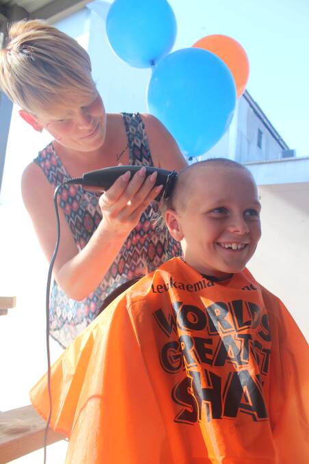 Brave: Kylie Streat shaved Caleb Barker's head at a World's Greatest Shave event at the Bunch Hotel late last year. Photo: Contributed