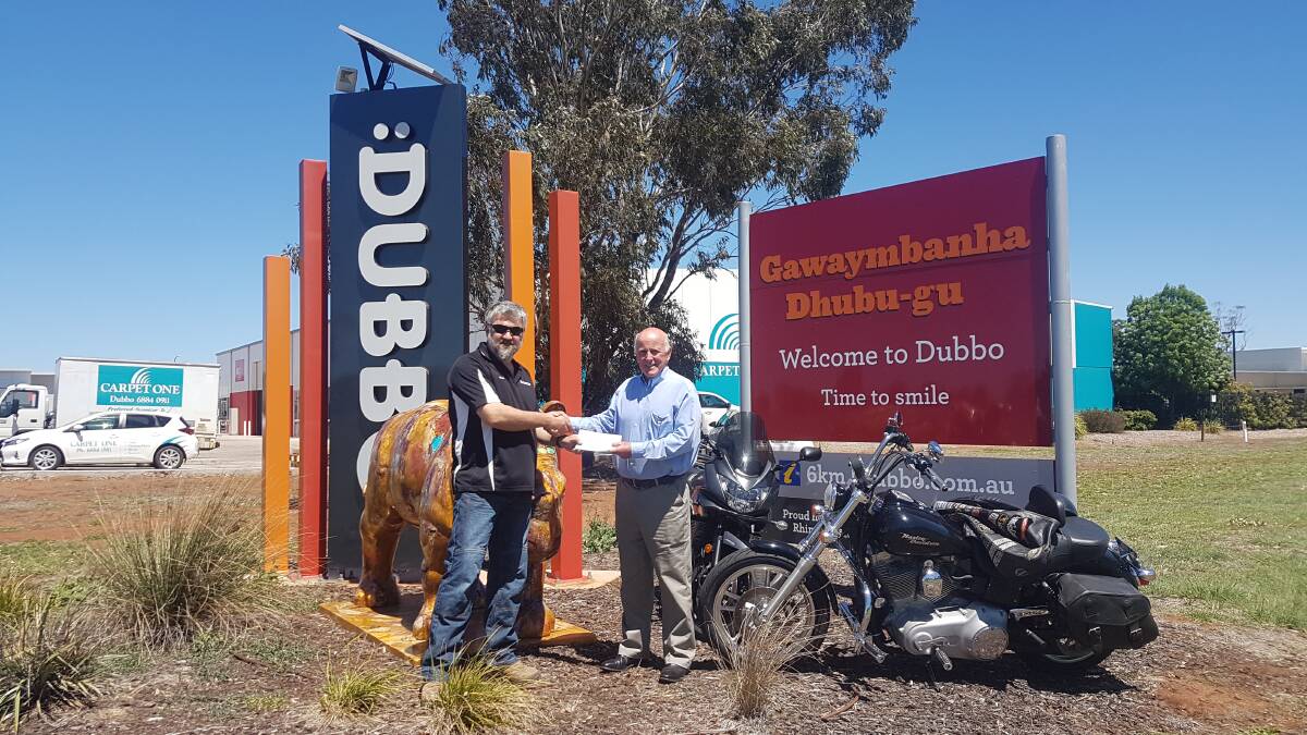 Welcome donation: Black Dog Ride and NSW co-ordinator Wayne Amor hands over a cheque to lifeline central west’s Alex Ferguson. Photo: Taylor Jurd 