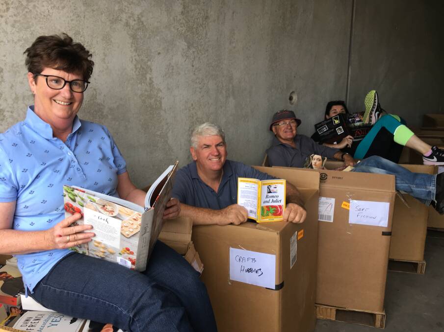 BOOKWORMS: Jennylee Milgate, book fair coordinator Peter English, Kevin Parker
and Macquarie Rotary Club president Jen Cowley check out some of the donated books. Photo: Contributed