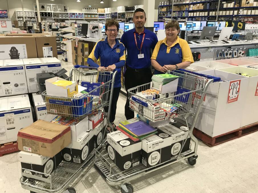 SHOPPING FOR OTHERS: Rotarians Deb McCreadie (left) and Pam Sharkey go on a shopping spree at Officeworks with the help of its shift manager Ramesh Sherchan. Photo: Contributed.