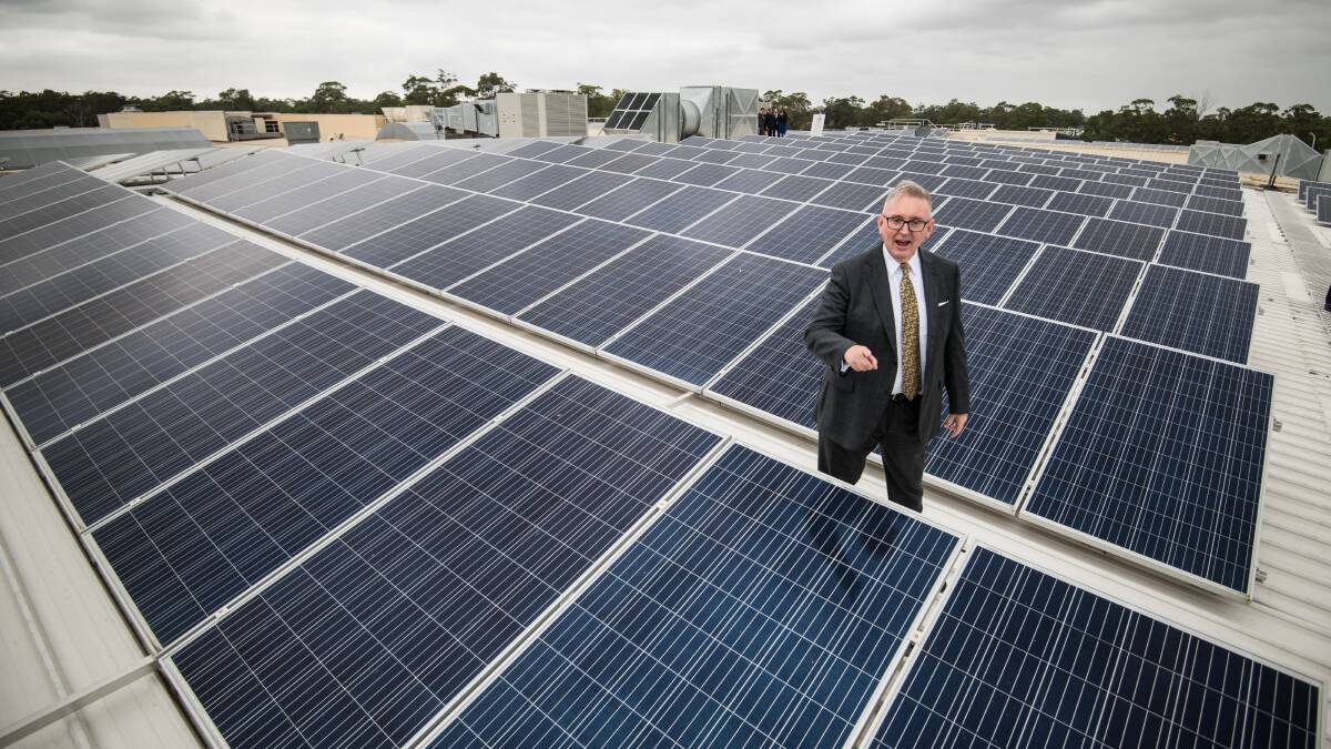 INSPECTION: NSW Minister for Resources and Utilities Don Harwin inspects solar panels on the rooftop at Stocklands Wetherill Park this week. Photo: WOLTER PEETERS.  
