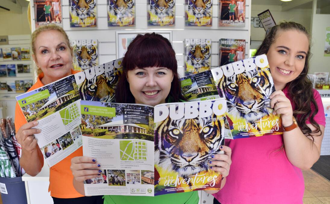 DUBBO DRAWCARDS: Dubbo Visitor Information Centre's Carmen Isbester, Ashleigh Allen and Gemma Handley display brochures highlighting the city's attractions. Photo: BELINDA SOOLE 