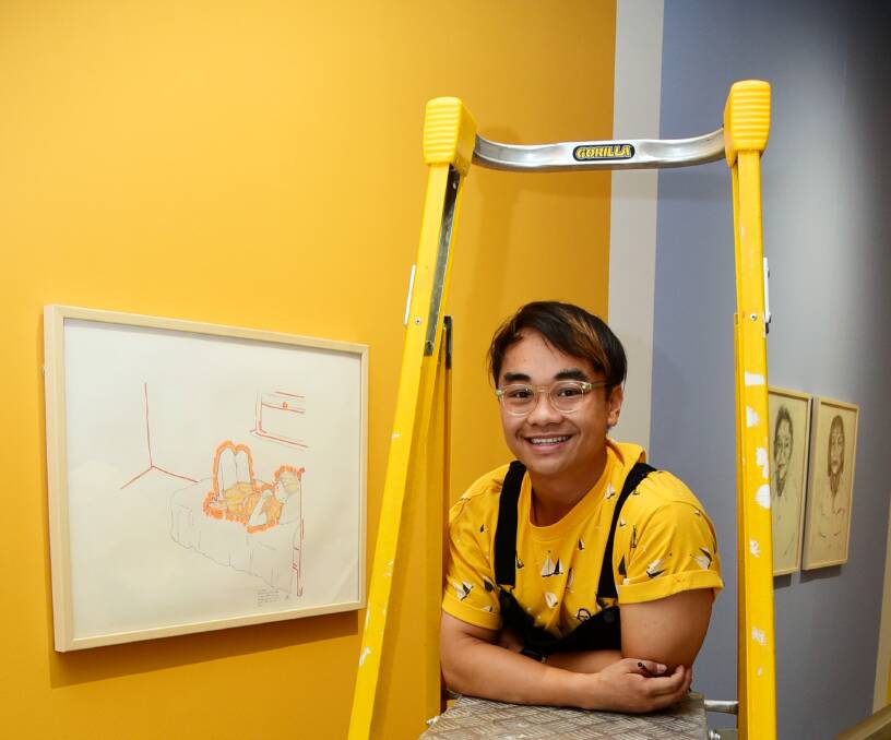 IN THE SPACE: Artist and art teacher Kieth Yap helps install his exhibition called twenty-seven at Western Plains Cultural Centre. Photo: BELINDA SOOLE
