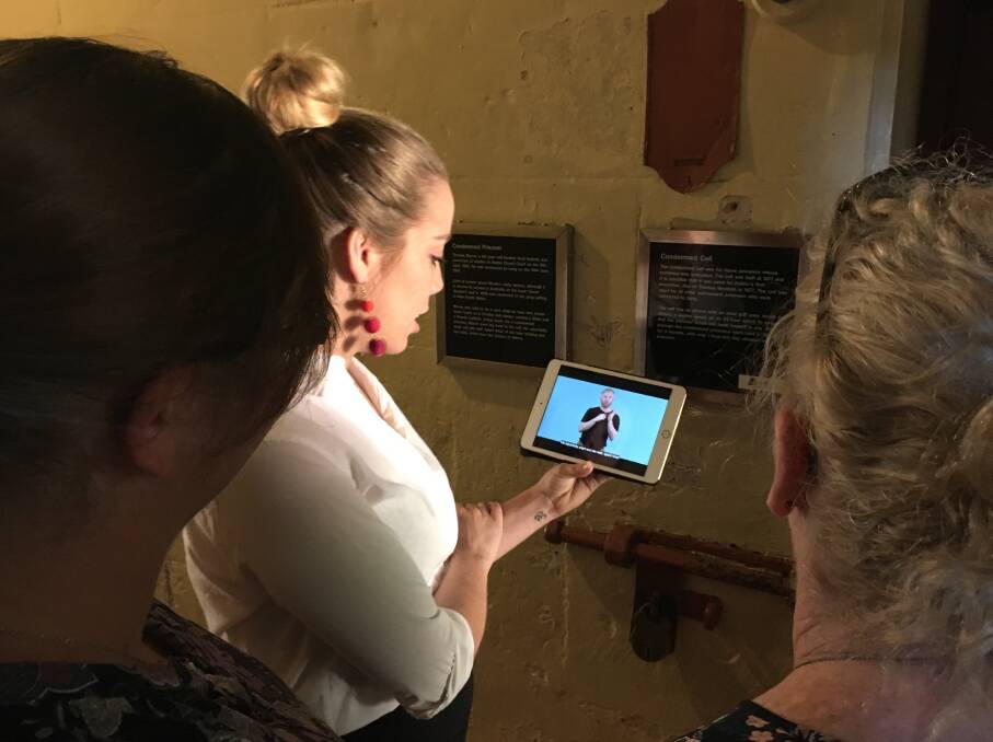 NEW APP: Old Dubbo Gaol's Jessica Hull shows visitors how the OpenAccess app allows  the "deaf and hard of hearing" to undertake self-guided tours. Photo: Contributed