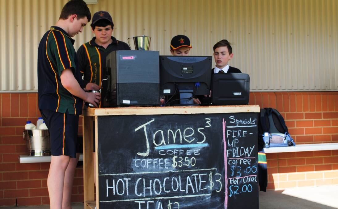 COFFEE TIME: James Barton, James Batten, James Lalor and Matthew McKechnie man the mobile drive-through coffee shop at Macquarie Anglican Grammar School. Photo: Contributed