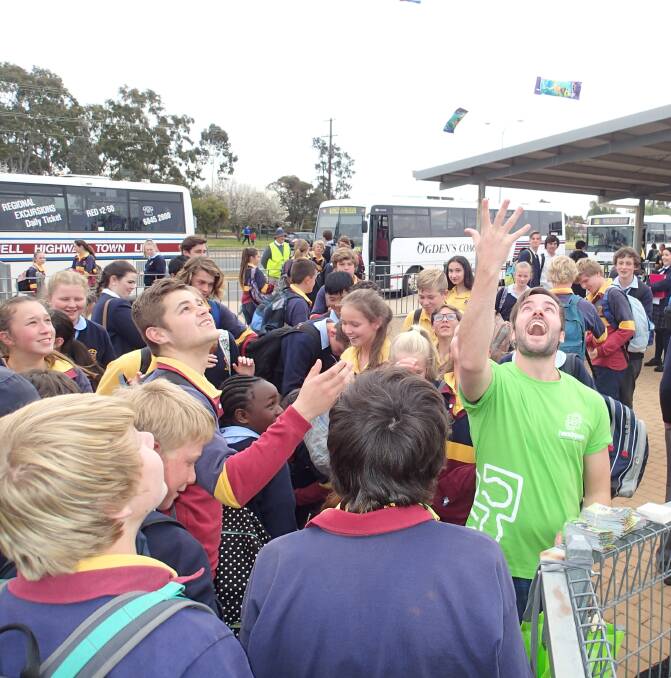ANNIVERSARY TREAT: Paul Rich (right) from headspace Dubbo shares chocolate with students of St John's College to celebrate the 10th anniversary of headspace, established and funded by the Commonwealth. Photo: Contributed