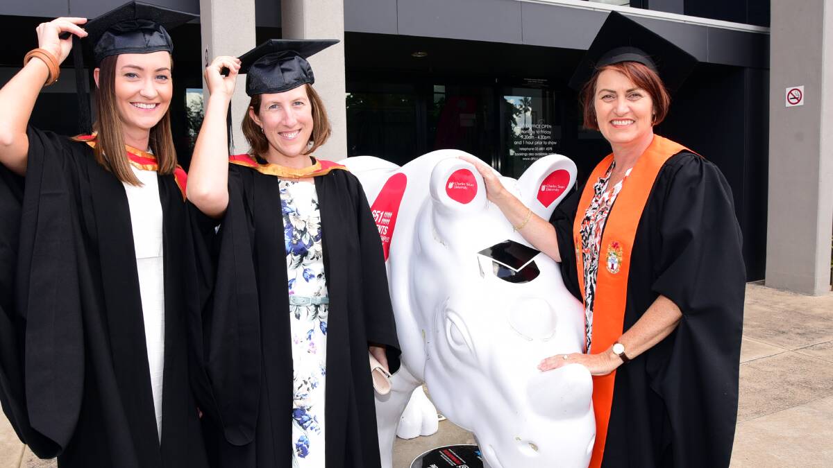 HATS OFF TO THEM: CSU in Dubbo head of campus Cathy Maginnis (right) congratulates Sophie Board (left) and Jocelyn McKay on their graduation day. Photo: BELINDA SOOLE