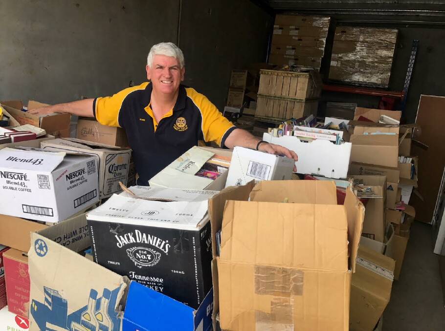 BOXES NEEDED: Rotary Club of Dubbo Macquarie's Peter English displays the kind of boxes needed to store books for its fair. Photo: Contributed. 