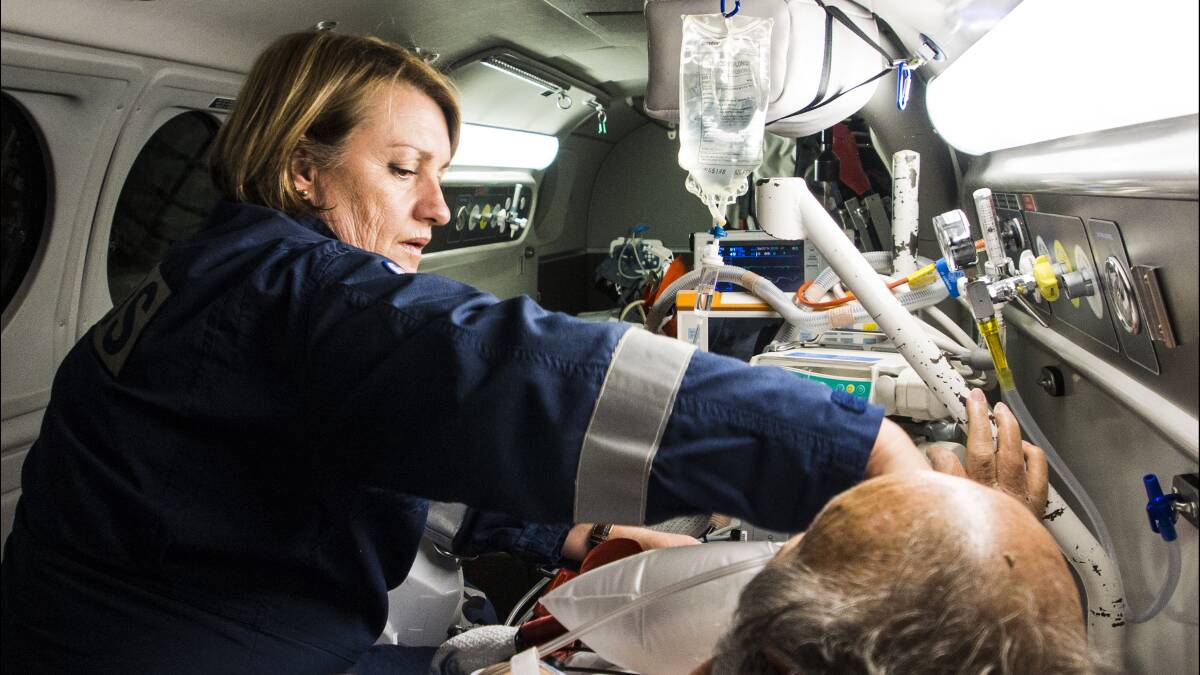 AT WORK: Senior flight nurse Karen Barlow treats a patient. Photo: Contributed
