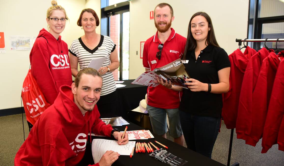 WARM WELCOME: Isaac Maginnis (kneeling) and Hannah Soole talk with head of campus at Charles Sturt University in Dubbo Cathy Maginnis and student ambassadors John Pluck and Alice Barber at the welcome day. Photo: BELINDA SOOLE