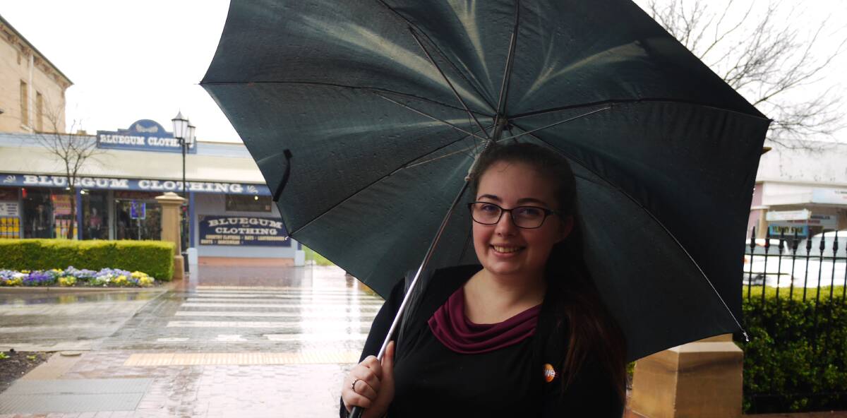 RAINY DAYS: Demi Grima of Dubbo tries to stay dry as the rain falls in the city's central business district on Wednesday morning. Photo: KIM BARTLEY