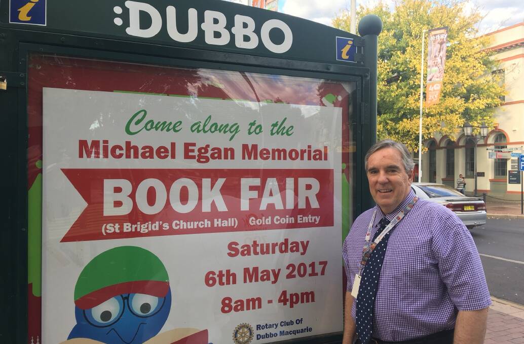 BOOKS GALORE: 2017 Michael Egan Memorial Book Fair coordinator Peter Bartley checks out signage promoting the one-day event at St Brigid's hall on May 6 at the Church street rotunda in Dubbo. Photo: Contributed