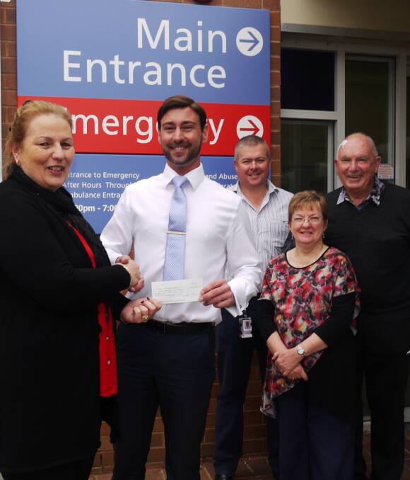 HANDOVER: Sandy Birkett-Williams gives the cheque for the ultrasound machine to Dr David Lord Cowell watched by ED operations manager Clint Gross and Rotarians Jeannette Miller and Barry Brebner. Photo: KIM BARTLEY