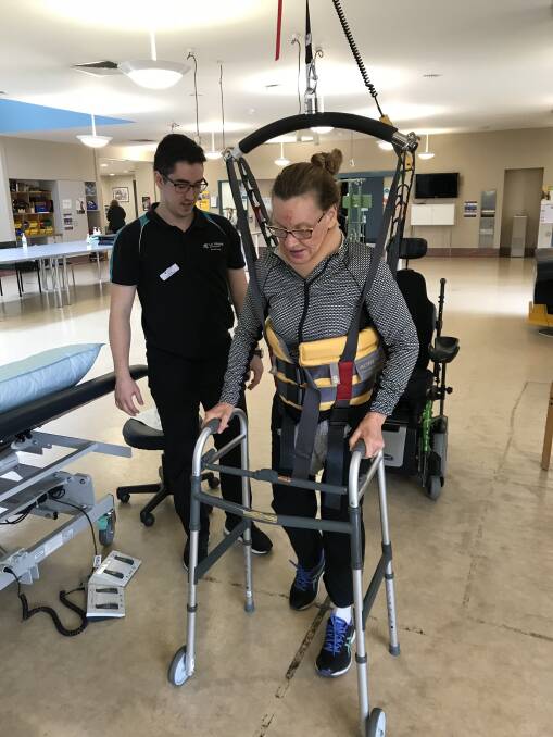One step at a time: Ange Ednie learns to walk again with the aid of a frame and a harness at the Royal Talbot Rehabilitation Centre in Melbourne.