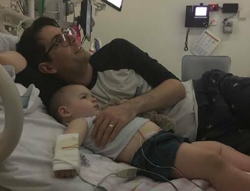 QUIET MOMENT: Lachie Eddy and dad Charles Eddy during one of Lachie's hospital stays.