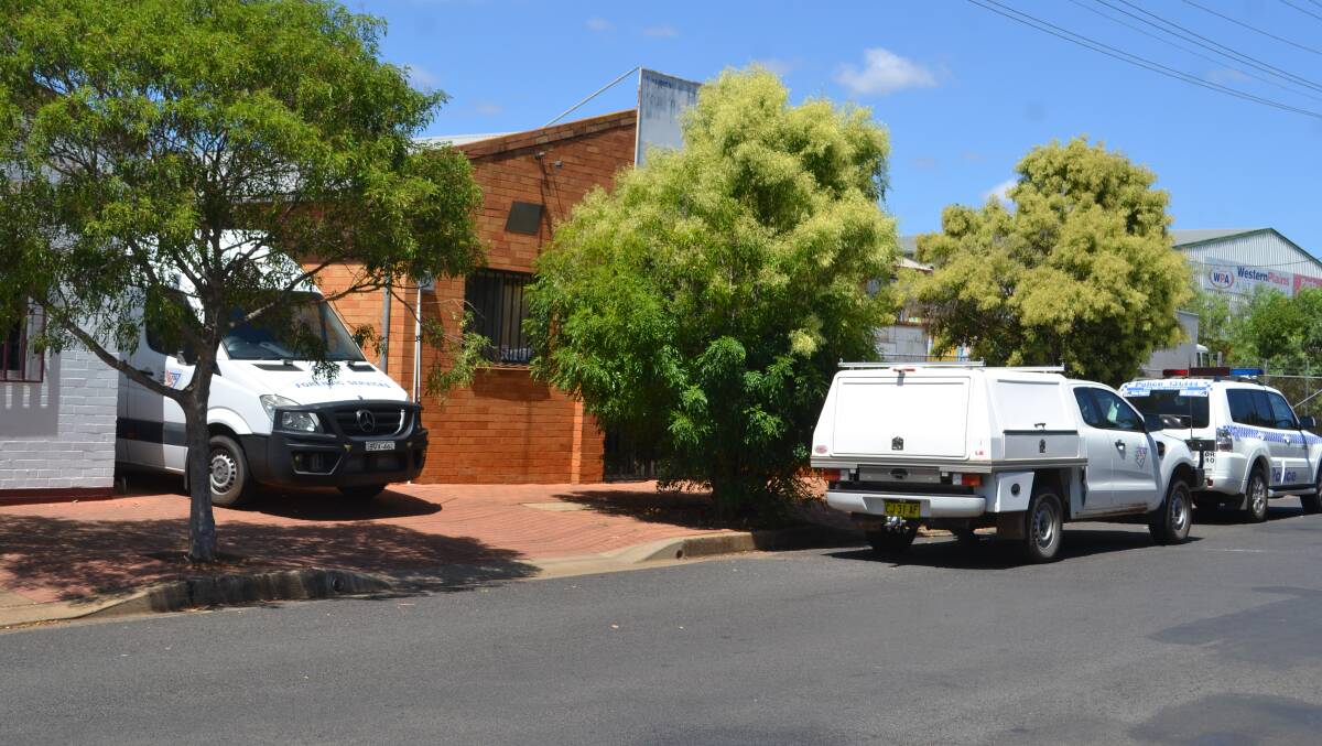 INVESTIGATION: Police and forensics vehicles outside a premises raided on Wednesday morning.