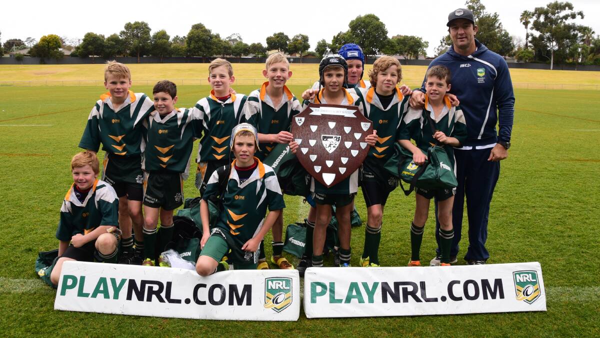 TOO GOOD: The St Joseph's side from Nyngan with the silverware and Parramatta legend Nathan Hindmarsh. Photo: BELINDA SOOLE