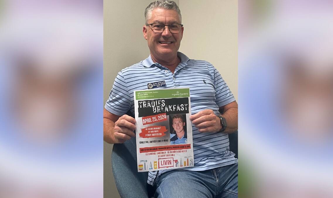 Mark Meredith with a flyer for this month's Tradies Breakfast.