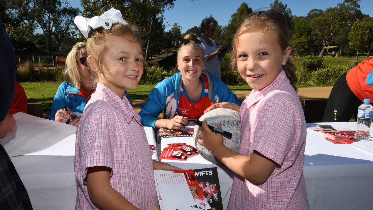 ALL SMILES: Maya Hyde and Mia Richardson pose for a photo with NSW Swift Maddy Turner after getting an autograph. Photos: BELINDA SOOLE