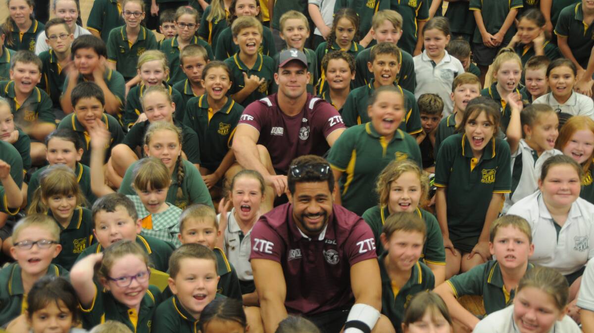 KINGS OF THE KIDS: Darcy Lussick (back) and Matt Wright with students from Dubbo North Primary School on Thursday. Photo: NICK GUTHRIE