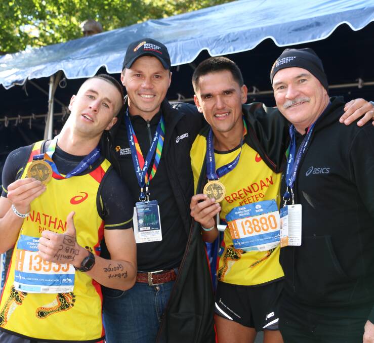 RUNNING FORWARDS: Robert de Castella (right) with IMP participants, including Dubbo's Nathan Riley (L), at the finish of the New York Marathon.