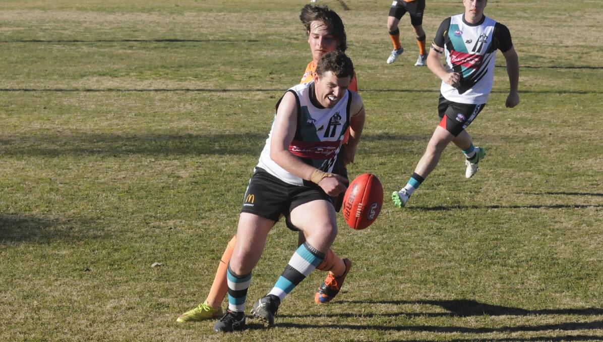 ON THE BALL: Rebels player Casey White works to win a possession against the Giants. Photo: CHRIS SEABROOK