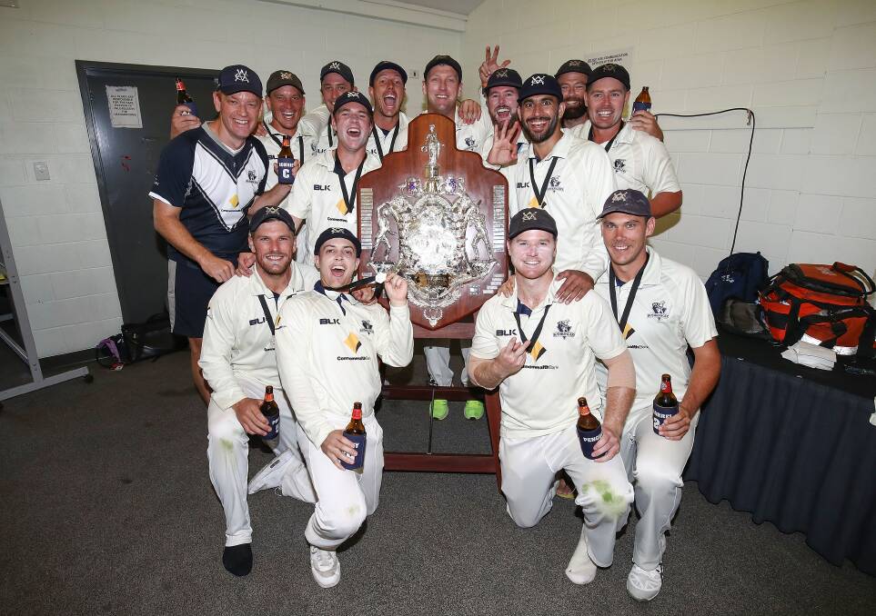 MOMENT TO REMEMBER: Chris Tremain (back, second from left) celebrates with his Victorian teammates after claiming the Sheffield Shield at Alice Springs on Thursday. Photo: GETTY IMAGES