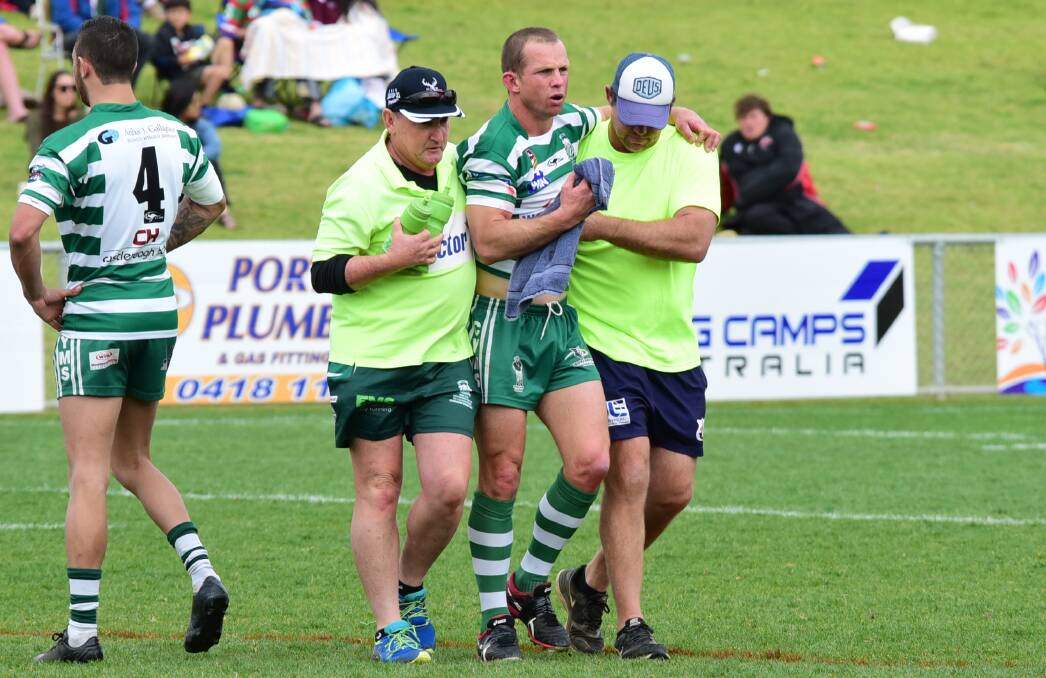 DAZED AND CONFUSED: CYMS captain Luke Jenkins is assisted from the field after being hit in a high tackle early on Sunday. Photo: BELINDA SOOLE