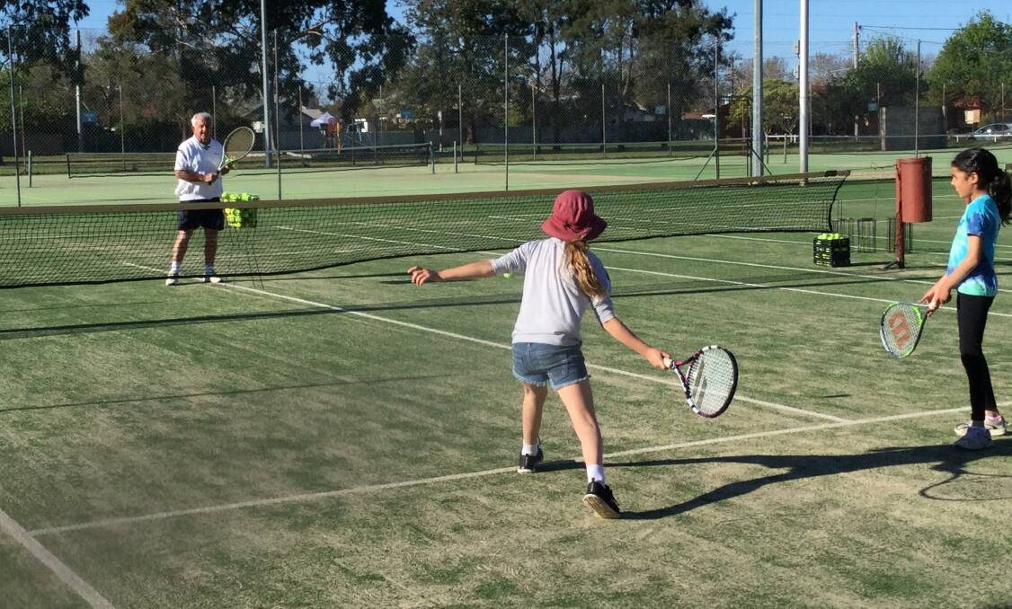 HELPING HAND: Bob Hough (left) has taken on a coaching role at the Muller Park Tennis Club following Pippa Higgins Earl's decision to return to the Gold Coast recently. Photo: CONTRIBUTED