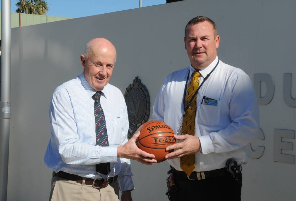 READY TO RUMBLE: Dubbo Basketball's Peter Hargreaves with Detective Senior Constable Rob Jackson, who will line up for the police team in Saturday's charity match and curtain-raiser to the Rams game. Photo: NICK GUTHRIE