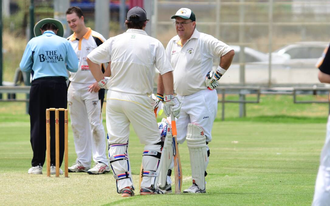 DOING A JOB: Greg Rummans (back turned) and Brian McKinnon led the way for South Dubbo on Saturday as the Hornets downed Newtown by 24 runs. Photo: BELINDA SOOLE