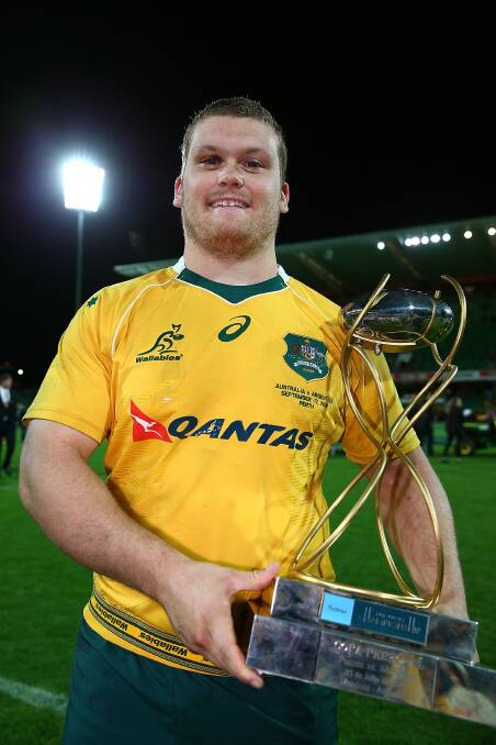 ALL SMILES: Tom Robertson with the silverware after helping the Wallabies defeat Argentina on debut. Photo: GETTY IMAGES