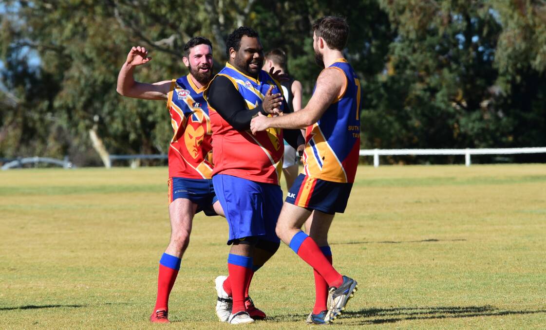 CHEER, CHEER: Trevor Green (centre) and the Dubbo Demons will be hoping to have reason to celebrate again after Saturday. Photo: BELINDA SOOLE