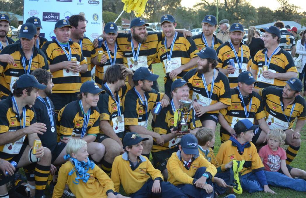 WINNERS ARE GRINNERS: The Trangie Tigers celebrate with the silverware after winning Saturday's grand final. Photo: CONTRIBUTED
