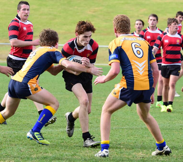 Here I come: Dubbo College sports captain Brandon Dodd takes on the Bathurst High defence.