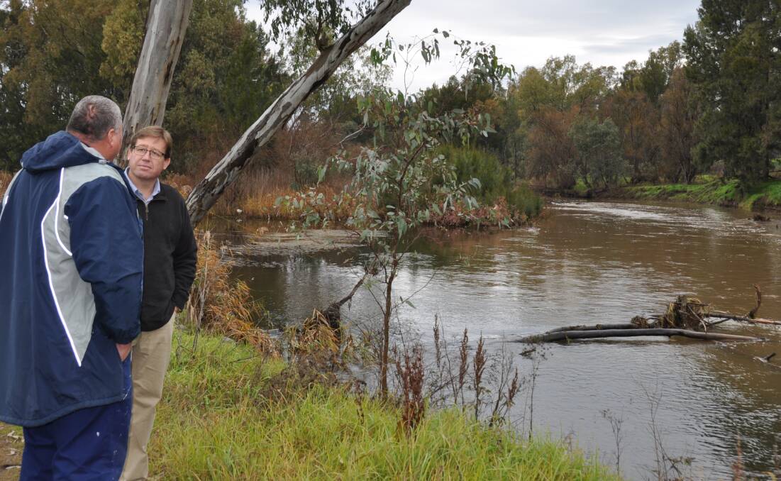 Troy Grant at the intersection of the Bell and Macquarie Rivers in Wellington chatting with a local about the recent rainfall in the area.
