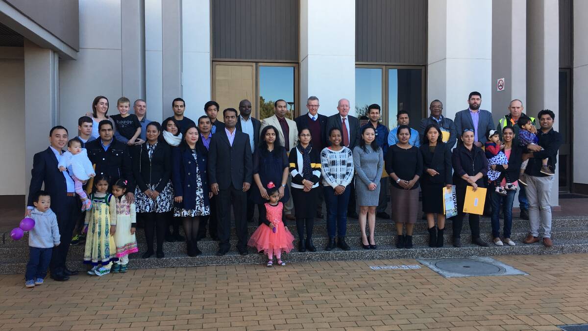 Federal Member for Parkes Mark Coulton and Dubbo Regional Council Administrator Michael Kneipp with the new citizens.