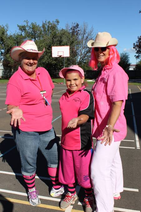 Miss Jeffery, Zion Hands and Ms Robinson celebrate Pink Day in 2014.