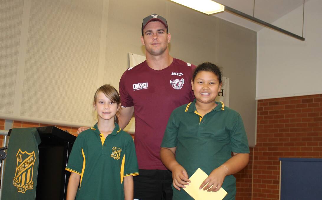  Malunna Robinson and Eva-Rose Dean posing with Manly’s Darcy Lussick.