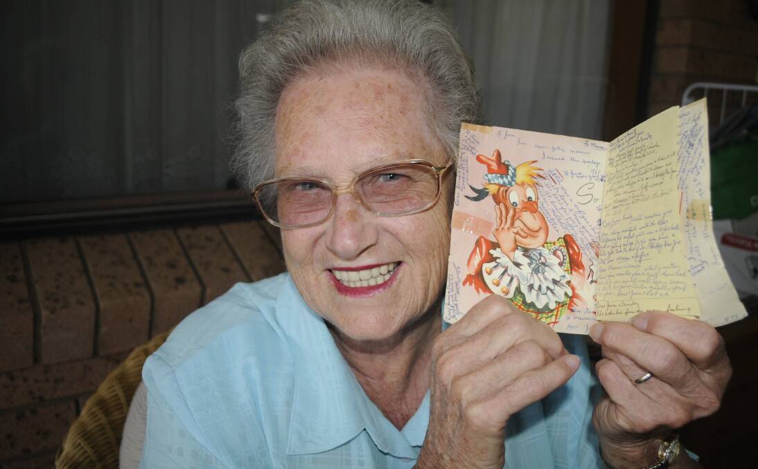 BACK AND FORTH: The same card has been sent back and forth between Bathurst's Maureen Clark (pictured) and her friend June Reedy in Forbes since 1957, with a new message added each time. Photo: CHRIS SEABROOK 011517card