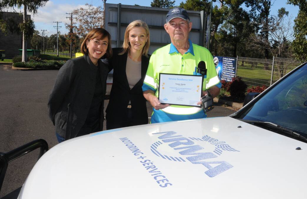 Dedicated service: NRMA general manager networks Melanie Konsil and executive general manager motoring Samantha Taranto present Trevor Quick with his award for 20 years of service. Photo: MARK RAYNER