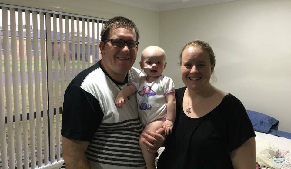 Trying circumstances: Keiran and Sarah Sharp with their daughter Grace, who is undergoing treatment for a rare form of cancer. Photo: CONTRIBUTED