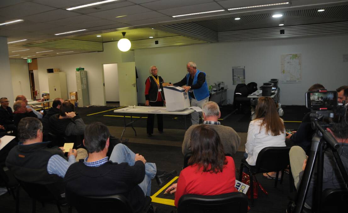 Returning officer Fiona Prentice and Peter Sadler conduct the ballot draw for Dubbo Regional Council on Wednesday night. Photo: MARK RAYNER