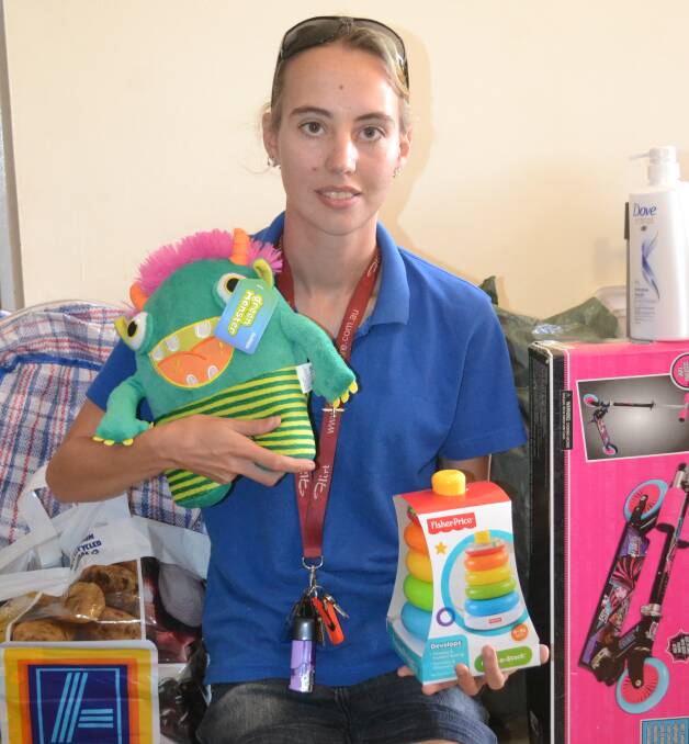 Madeline Best with some of the items people had donated to help residents affected by the Sir Ivan fire. Photo: MARK RAYNER