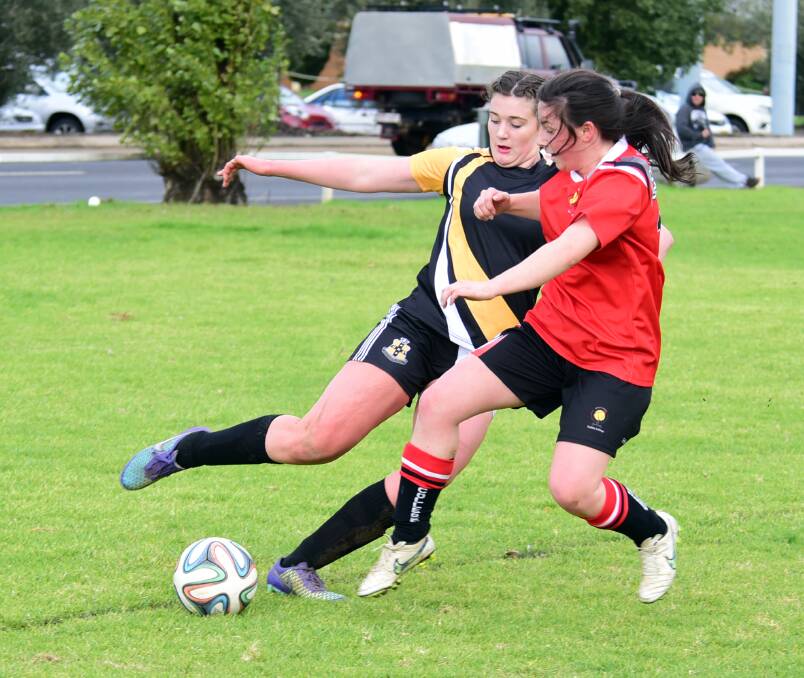 FIGHT FOR POSSESSION: Dubbo's Ashlee Finch competes with Orange's Jess Puxty for the ball during the girl's soccer. Photo: Belinda Soole