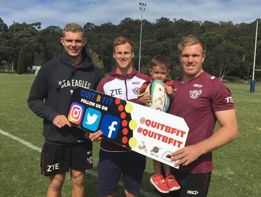 Special message: Manly's Tom Trbojevic, Daly Cherry-Evans and Jake Trbojevic with Sage Ah-See and the signage promoting Quit B Fit. Photo: CONTRIBUTED