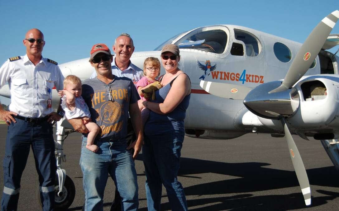 Helping hand: Pilot Chad Dunn with Wings4Kidz’s Kevin Robinson and Esther, John, Molly and Rachel Lillyman on one of the family's flights.
