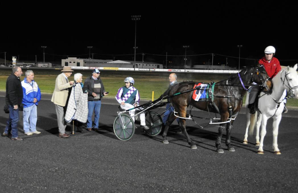 DESERVING WINNER: John O'Shea is congratulated on the win as part of a presentation by Dubbo Harness Racing Club patrons. Photo: HOLLY GRIFFITHS