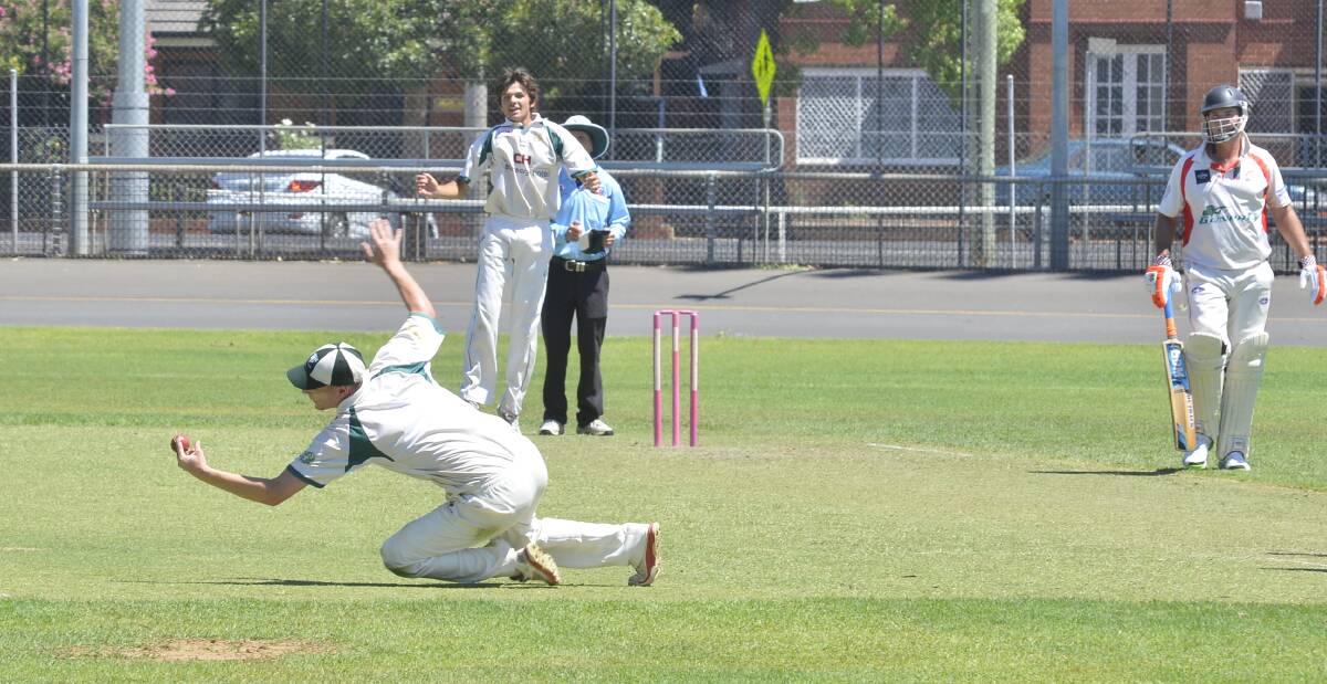 Nice one: CYMS fielder Lewis Mathews takes a great catch to dismiss Nathan Jones as bowler Brock Larance celebrates in the background. RSL-Colts went on to win the match. Photo: PAIGE WILLIAMS